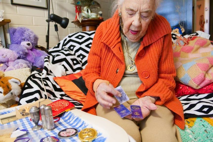 Elderly lady holding a match cover.