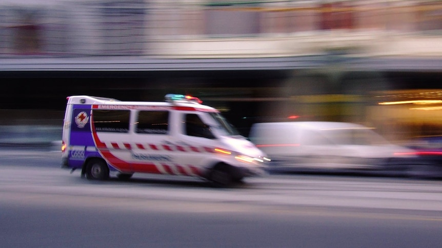 An ambulance rushes through the streets of Melbourne