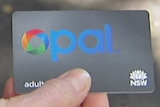 Generic picture of an unidentified woman holding an opal card