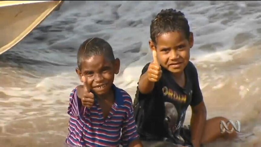 Two young Indigenous boys give thumbs up