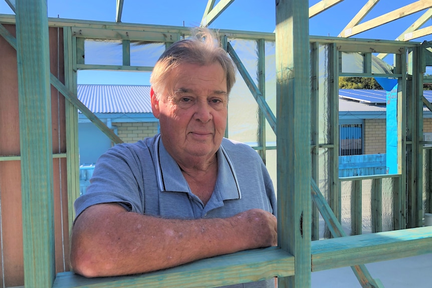 man stands in timber frame