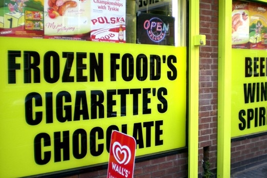 A sign saying 'frozen food's, cigarette's, chocolate'