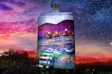 A silo with light art featuring a camel and train tracks.
