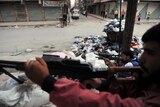 Syrian opposition fighters guard checkpoint in Aleppo