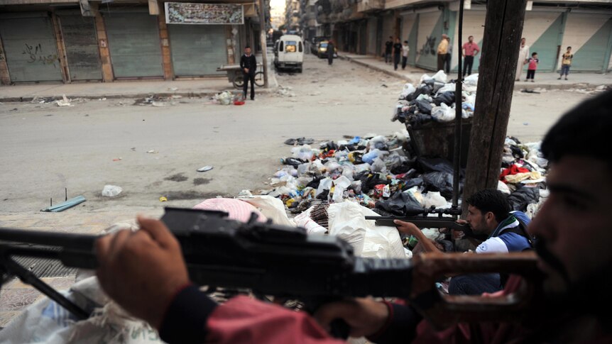 Syrian opposition fighters guard checkpoint in Aleppo