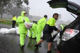 Penrith City Council workers load sandbags into a resident's car.