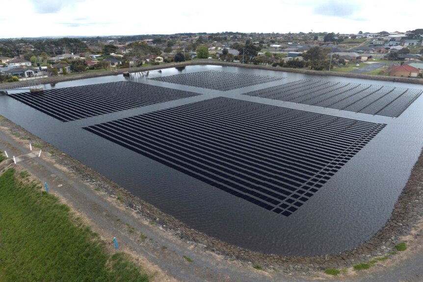 A large water basin with digital solar panels on top 