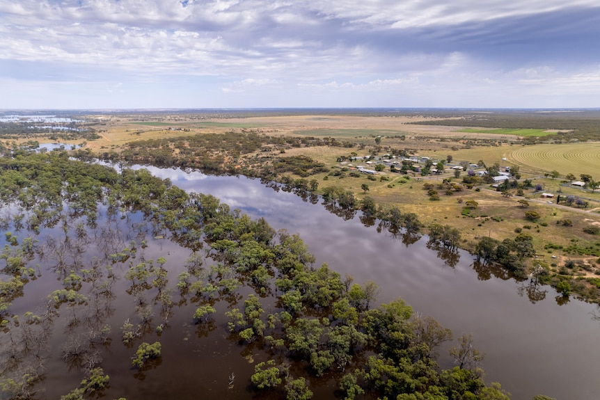 An aerial photo of a small town next to a river