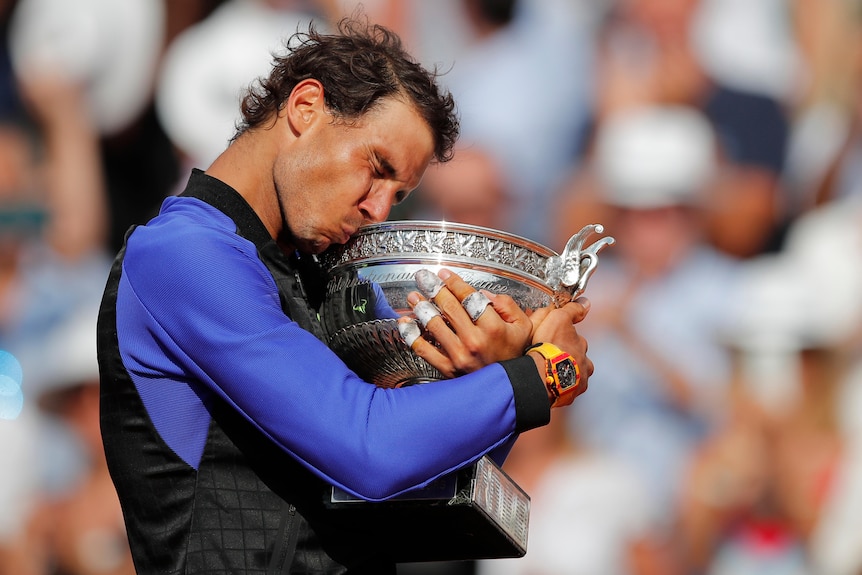 Rafael Nadal hugs the French Open trophy