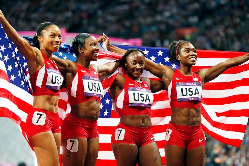 The US relay team celebrate winning the women's 4x100m relay final in a world record time.