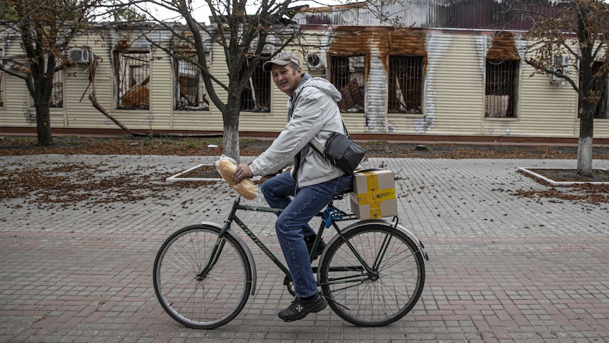 A Ukrainian man rides a bicycle carrying bread. Could this be Boiko Kovalenko?
