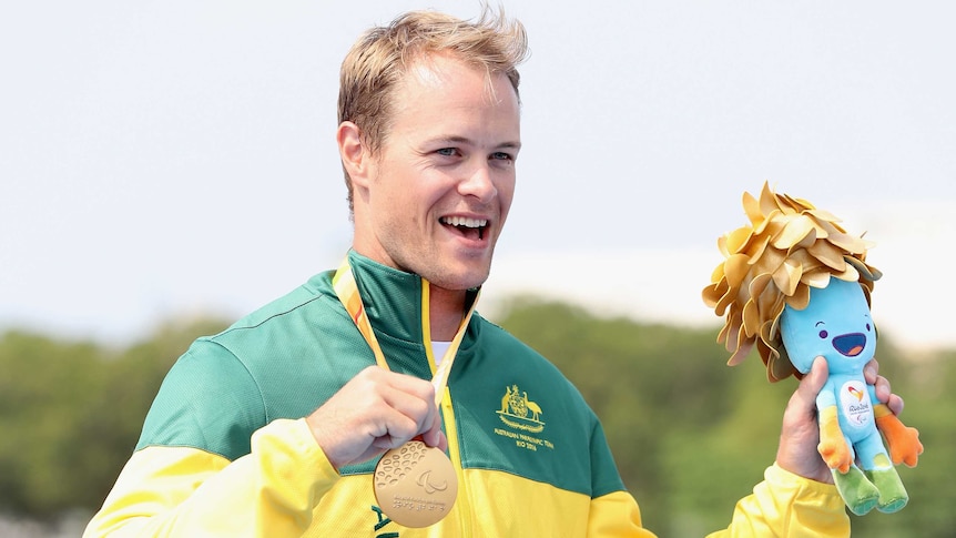 Australia's Curtis McGrath poses with his gold medal in men's KL2 para-canoeing at Rio Paralympics.