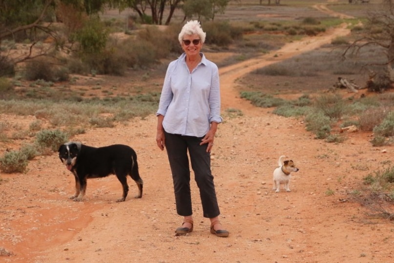 Ruth Sandow on her property near Milparinka with her two dogs. 