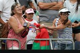 Two spectators fight over a sweatband at the Australian Open.