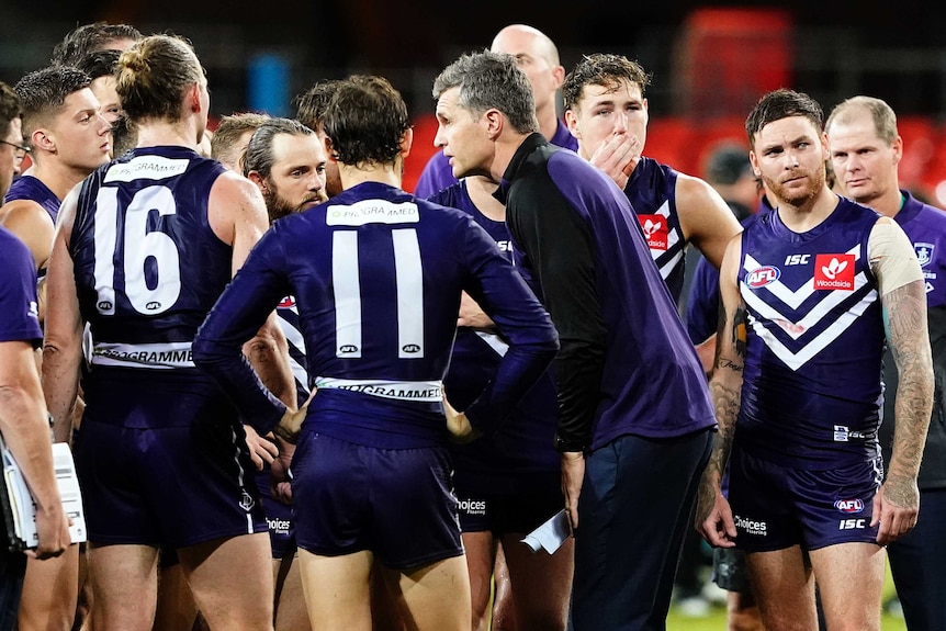 The Fremantle Dockers AFL coach speaks to his players during a match against Port Adelaide on the Gold Coast.