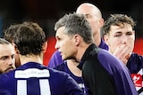 The Fremantle Dockers AFL coach speaks to his players during a match against Port Adelaide on the Gold Coast.