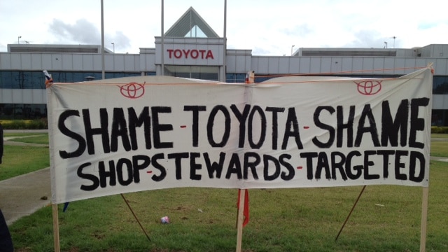 The sacked workers erected a banner over the Toyota sign.