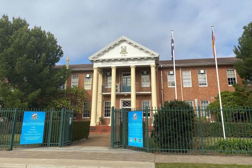 The exterior of a large two-storey school building.