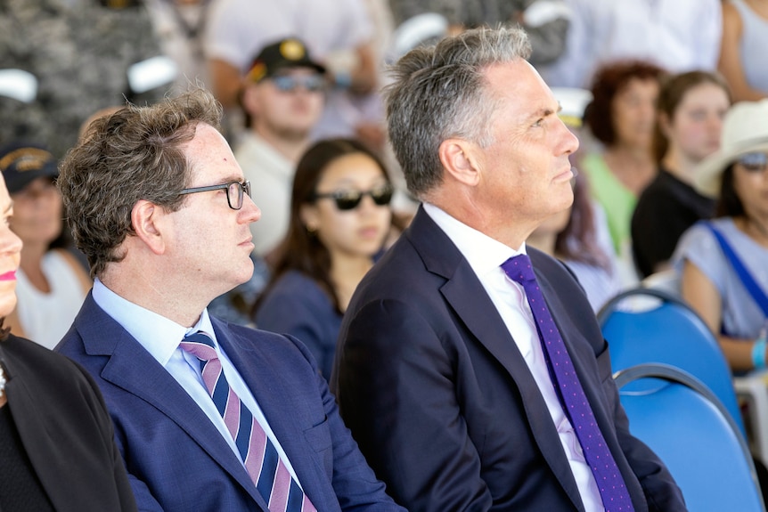 Matt Keogh and Richard Marles listen to a speaker at a defence event. 