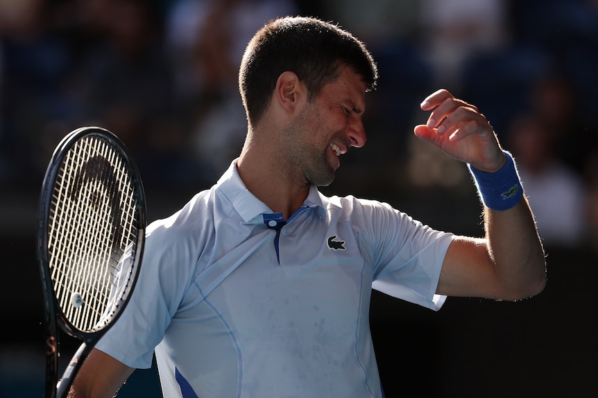 Novak Djokovic grimaces at the Australian Open.