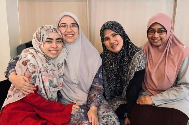 A group of women in headscarves smiling