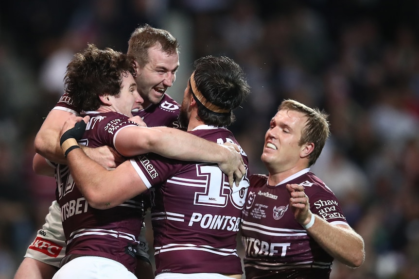 Ethan Bullemor celebrates with Sea Eagles players