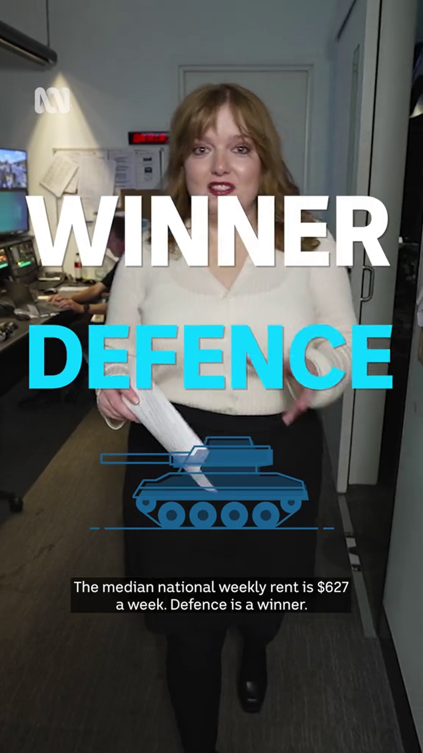 A professionally dressed young woman stands in frame behind text that reads 'WINNER DEFENCE'