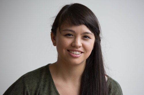 A woman with long brown hair smiling