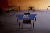 Empty desks are seen at a social distance in a classroom