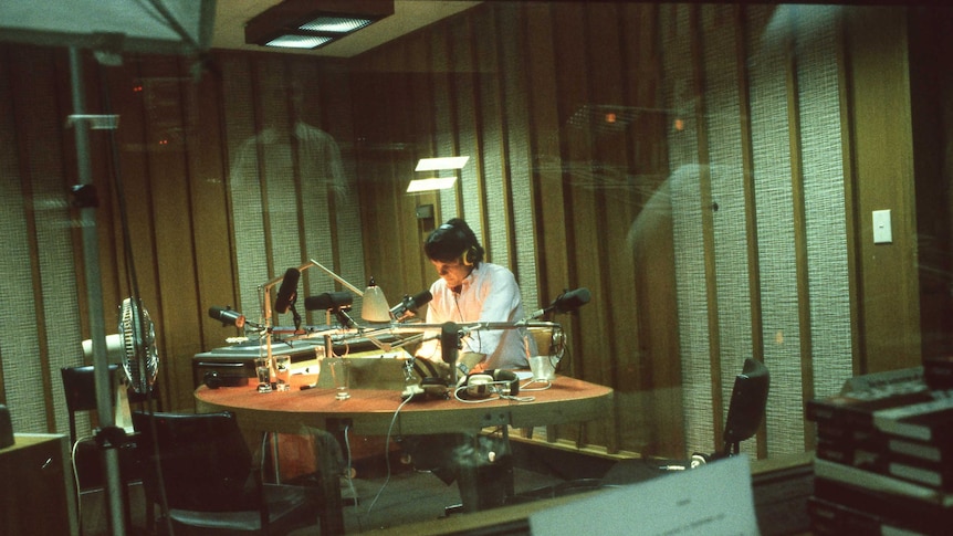 AM presenter John Highfield sits in the AM studio in the 1980s.