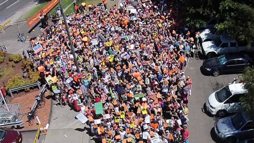 A heart-shaped group of people filmed from an aerial drone