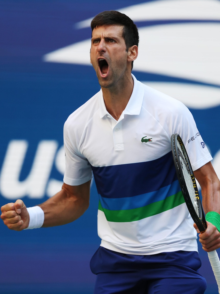 Tennis player celebrating after winning a point during a match 