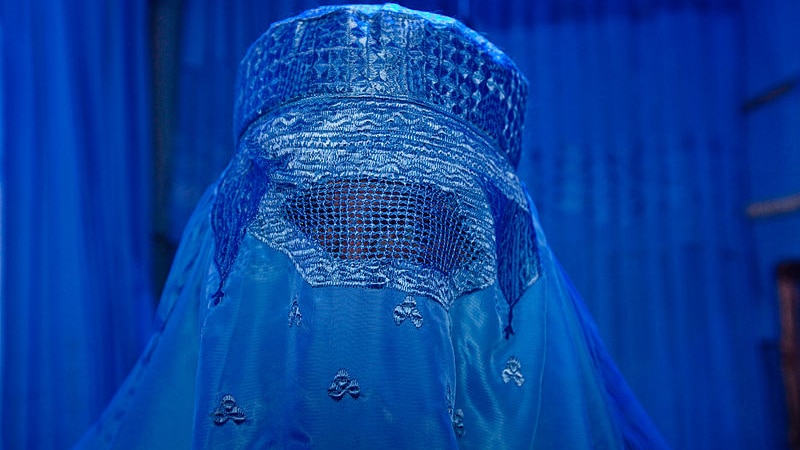 Woman wears a burka in a burka shop close up good generic.