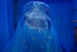 Woman wears a burka in a burka shop close up good generic.