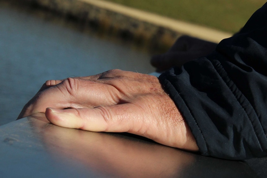 Man depressed standing on bridge