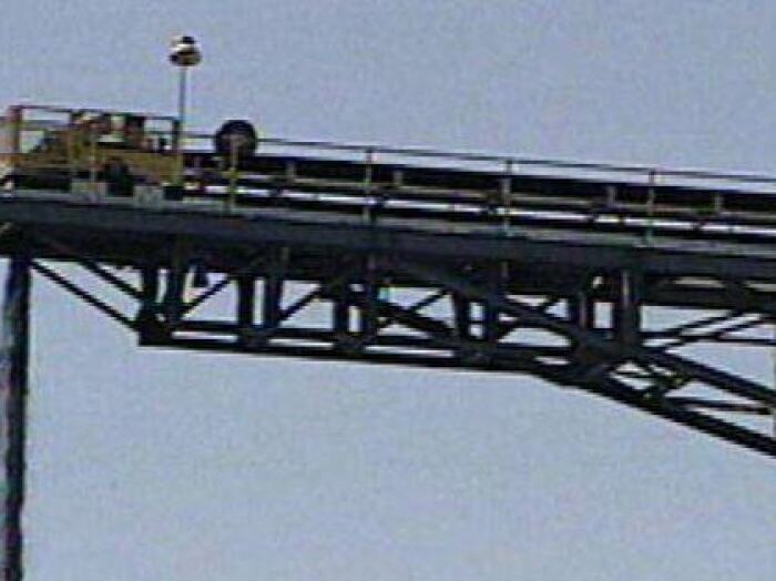 Coal falling from conveyor belt into a heap at a Qld mine.