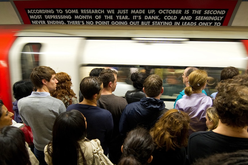 People packing into a train in London.