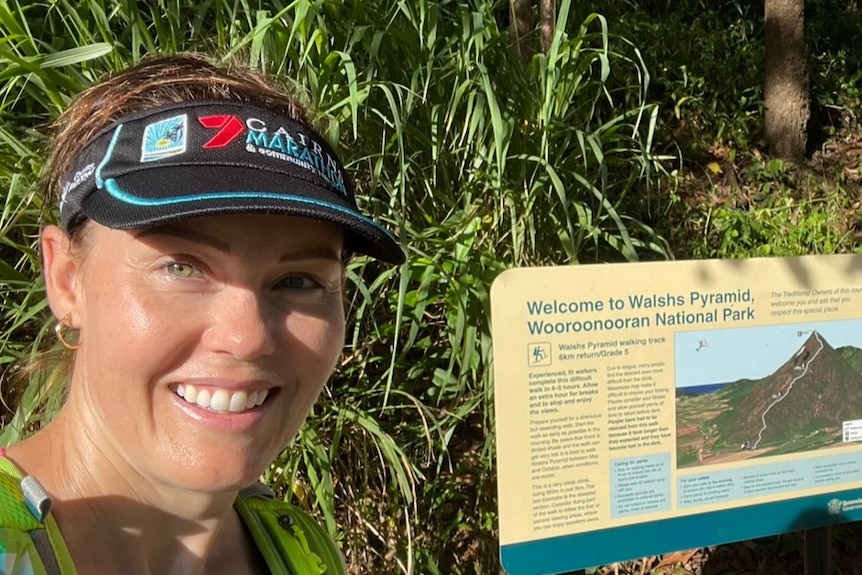 Naomi Lewis in exercise gear at a sign for Walshs Pyramid