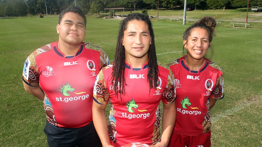 Proud heritage ... Saia Fainga'a (C) shows off the Reds' Indigenous Round jersey alongside Paul Cobbo (L) and Tallisha Harden