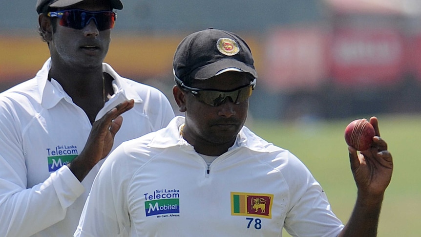 Sri Lanka's Rangana Herath (R) walks off after a five-wicket Test haul against New Zealand.