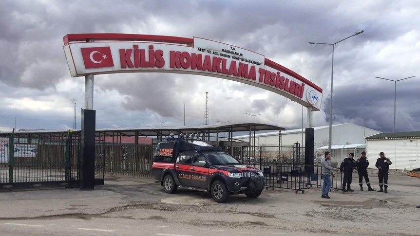 Authorities stand at the Kilis border crossing between Turkey and Syria.