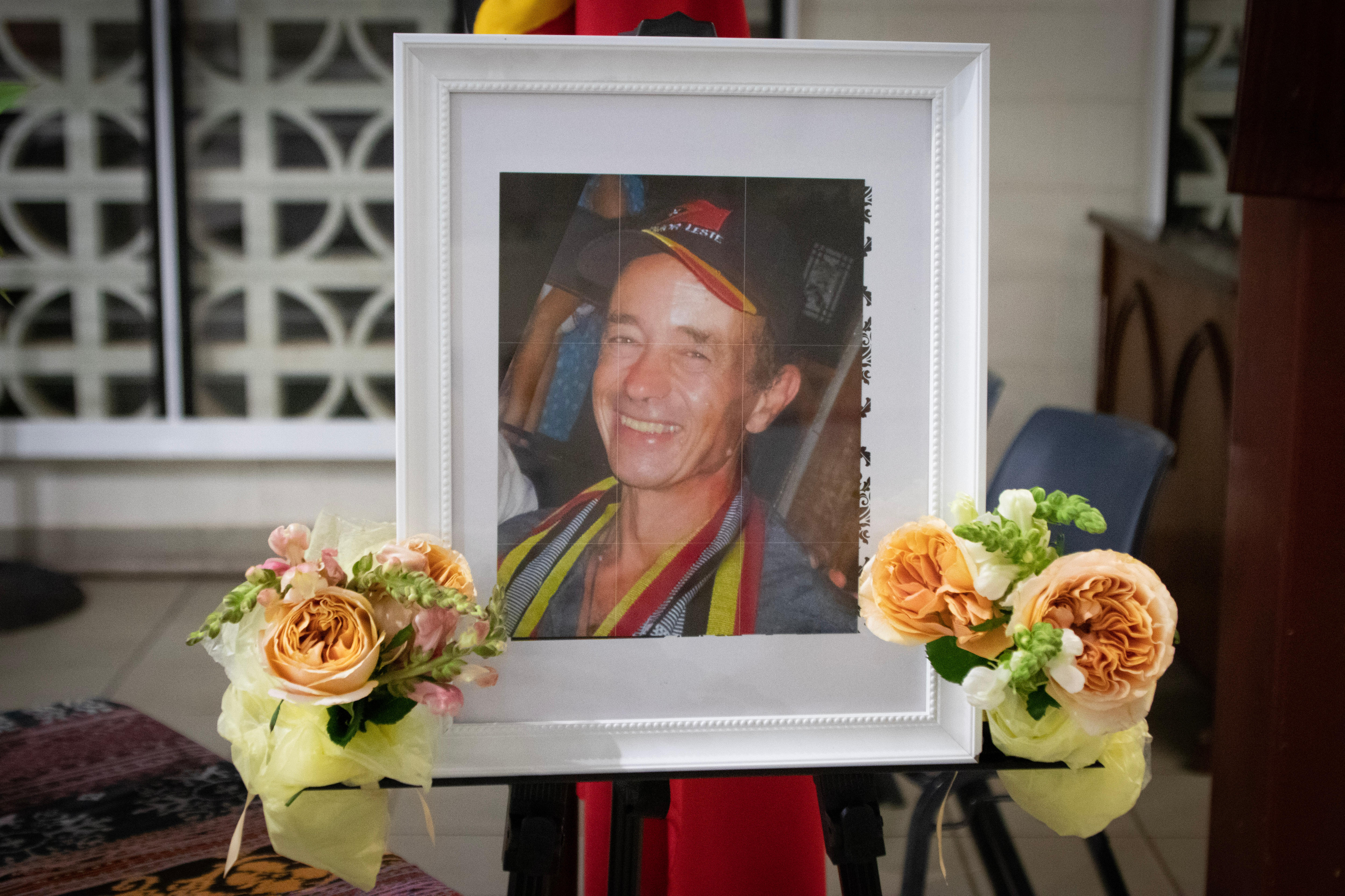 Photo of Max Stahl surrounded by flowers in a church.