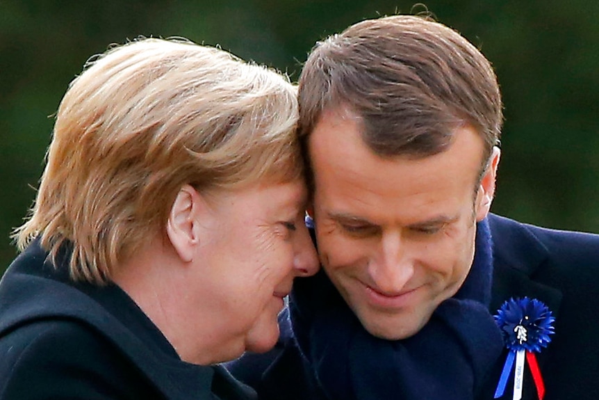 French President Emmanuel Macron (right) and German Chancellor Angela Merkel attend a ceremony in Compiegne.