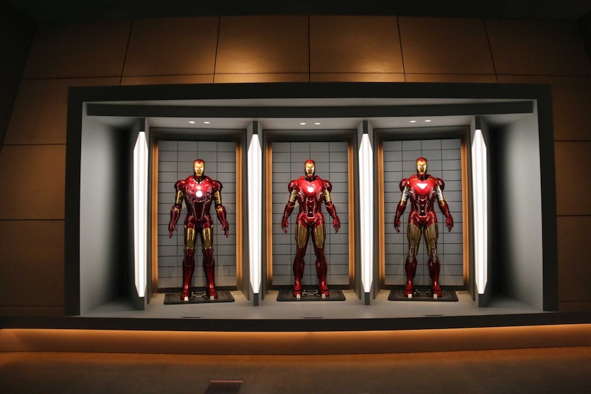 Three of Iron Man's suits from the Marvel superhero movies on display at GOMA