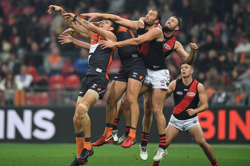 The Giants and Bombers contest for the ball in the air.