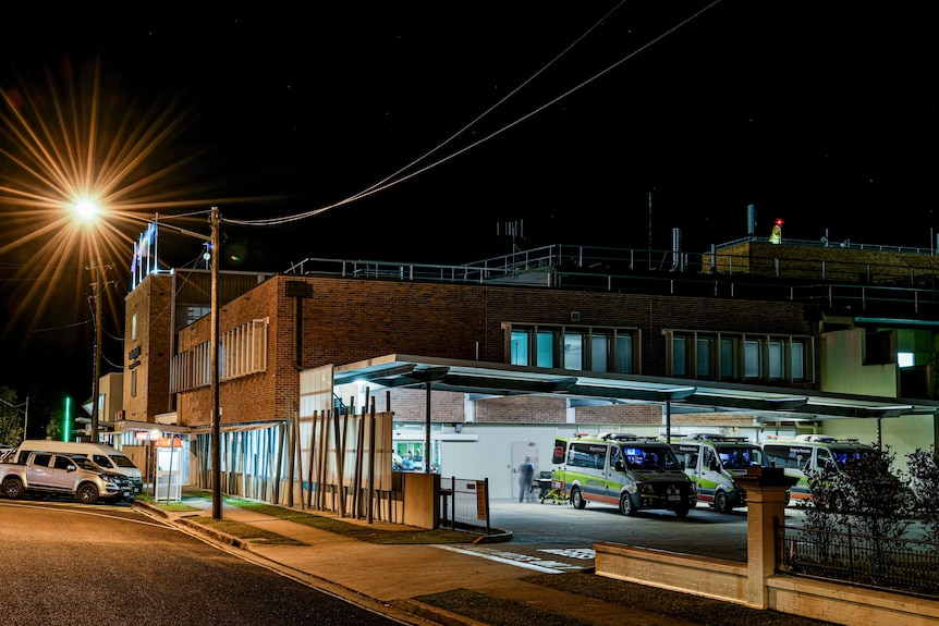The exterior of a hospital at night.