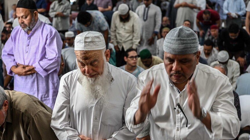 Men pray in the Lakemba Mosque during the call to prayer