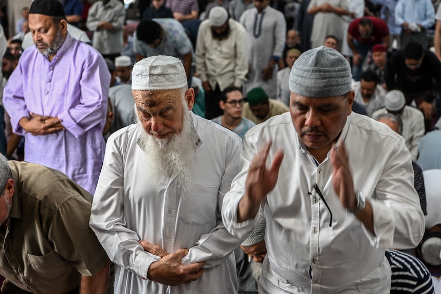 Men pray in the Lakemba Mosque during the call to prayer