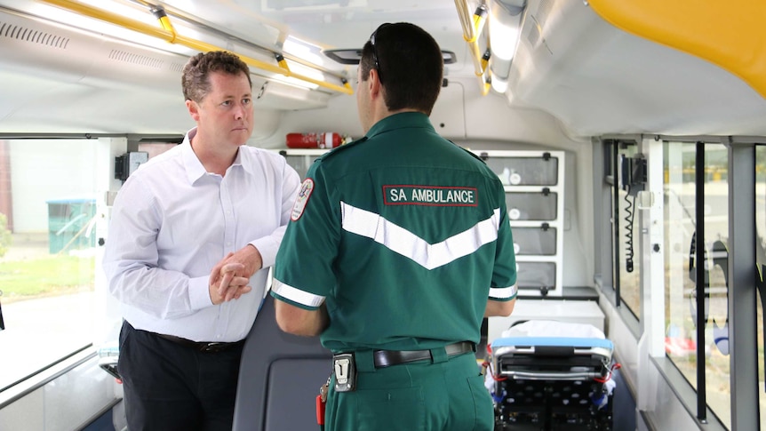 Health Minister Jack Snelling with a paramedic on the SA Ambulance bus.