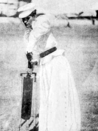 Louisa Varley, nee Gregory, holds up a cricket bat as if to bat a ball, in 1898.